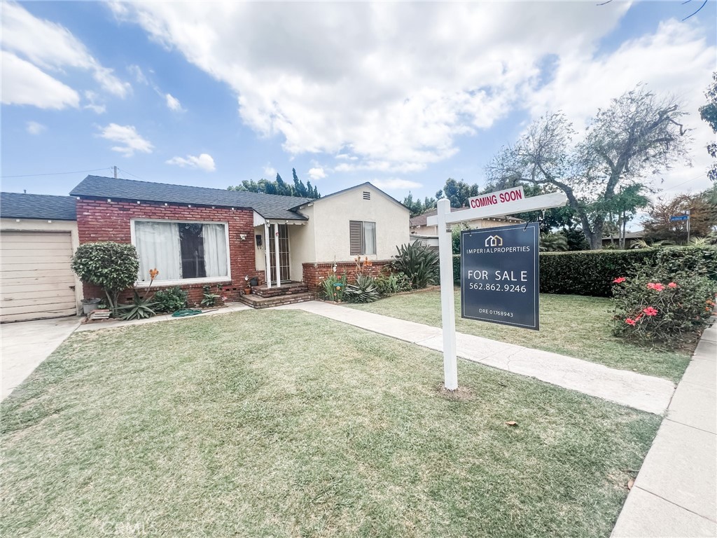 8206 Jackson Street Paramount, CA 90723 - Photo 9 of 9 a front view of a house with a yard and garage