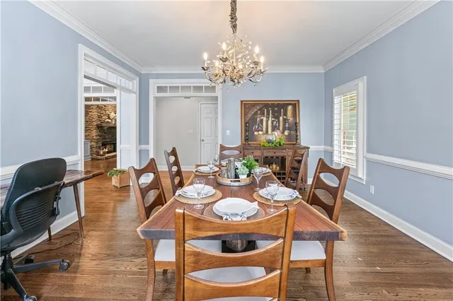 a living room with furniture a flat screen tv and a table