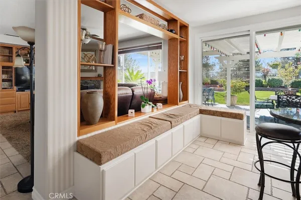 a living room with furniture a floor to ceiling window and a flat screen tv