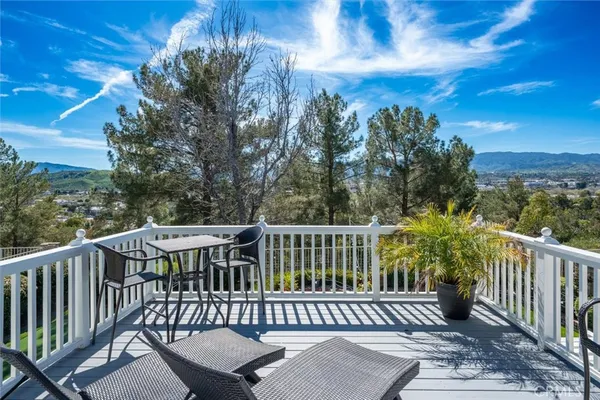a view of a balcony with wooden floor