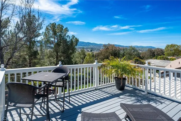 a bathroom with a granite countertop sink a mirror a vanity and shower