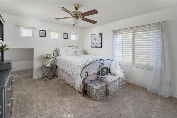 a bed room with a bed window and a chair
