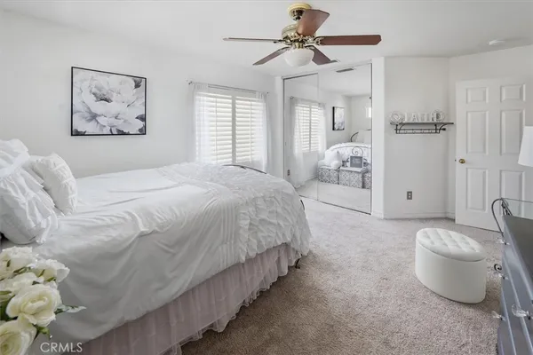 a bedroom with a bed cabinets and flat screen tv