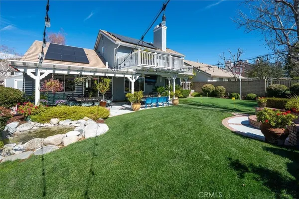 a view of an outdoor dining space with a table and chairs