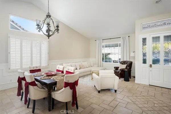a large kitchen with kitchen island granite countertop wooden cabinets a stove a sink and a large window