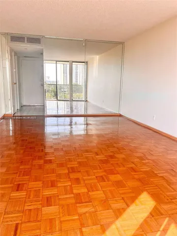 a view of empty room with floor to ceiling window