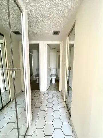 a view of a bathroom with a sink and a mirror