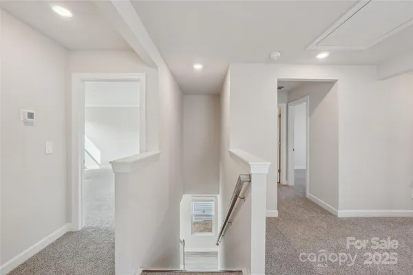a view of a hallway with furniture