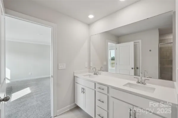 a bathroom with double sink and a mirror