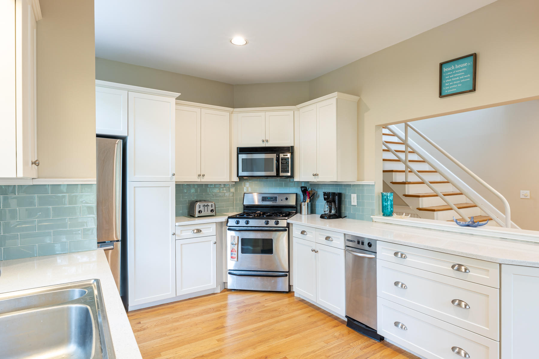185 Uncle Percy's Road Mashpee, MA 02649 - Photo 8 of 21 a kitchen with white cabinets and stainless steel appliances