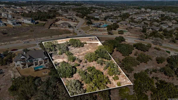an aerial view of a residential houses with outdoor space