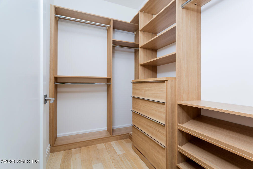 89 River Road, Unit 203 Cos Cob, CT 06807 - Photo 14 of 27 a view of walk in closet with empty racks