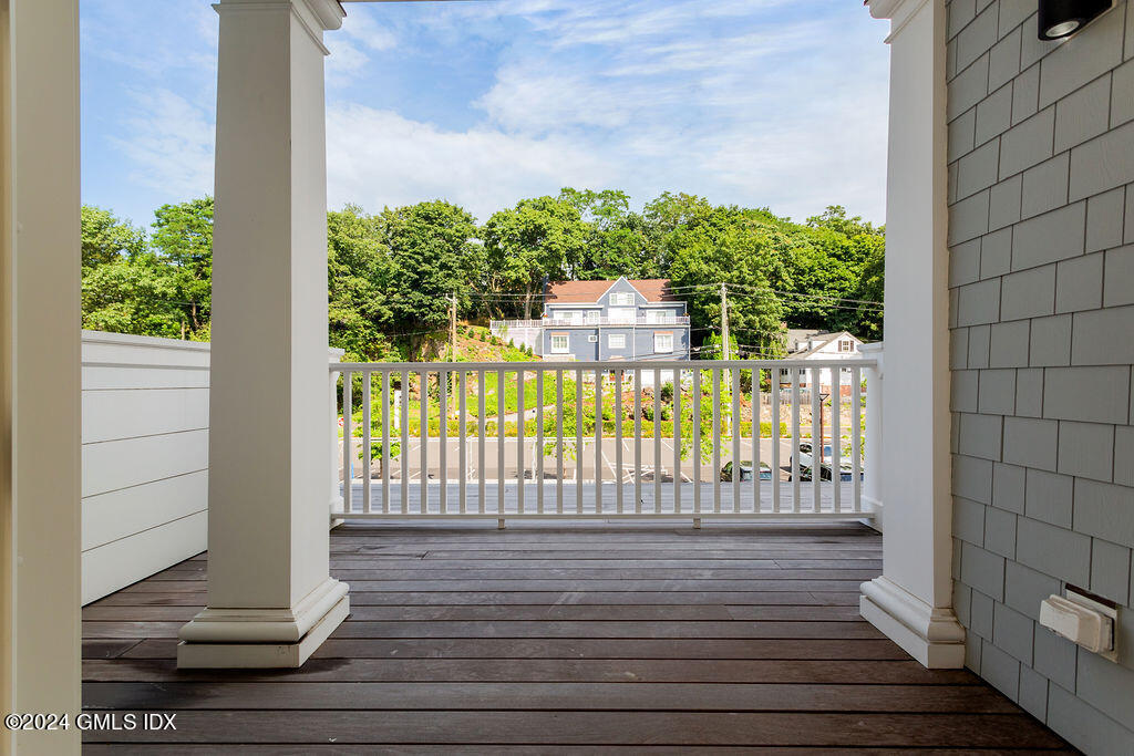 89 River Road, Unit 203 Cos Cob, CT 06807 - Photo 17 of 27 a view of a door with wooden fence