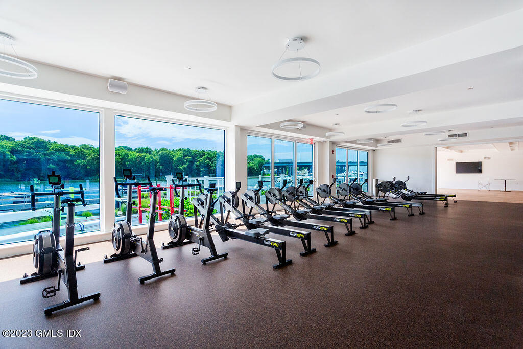 89 River Road, Unit 203 Cos Cob, CT 06807 - Photo 24 of 27 a view of a room with gym equipment and floor to ceiling window