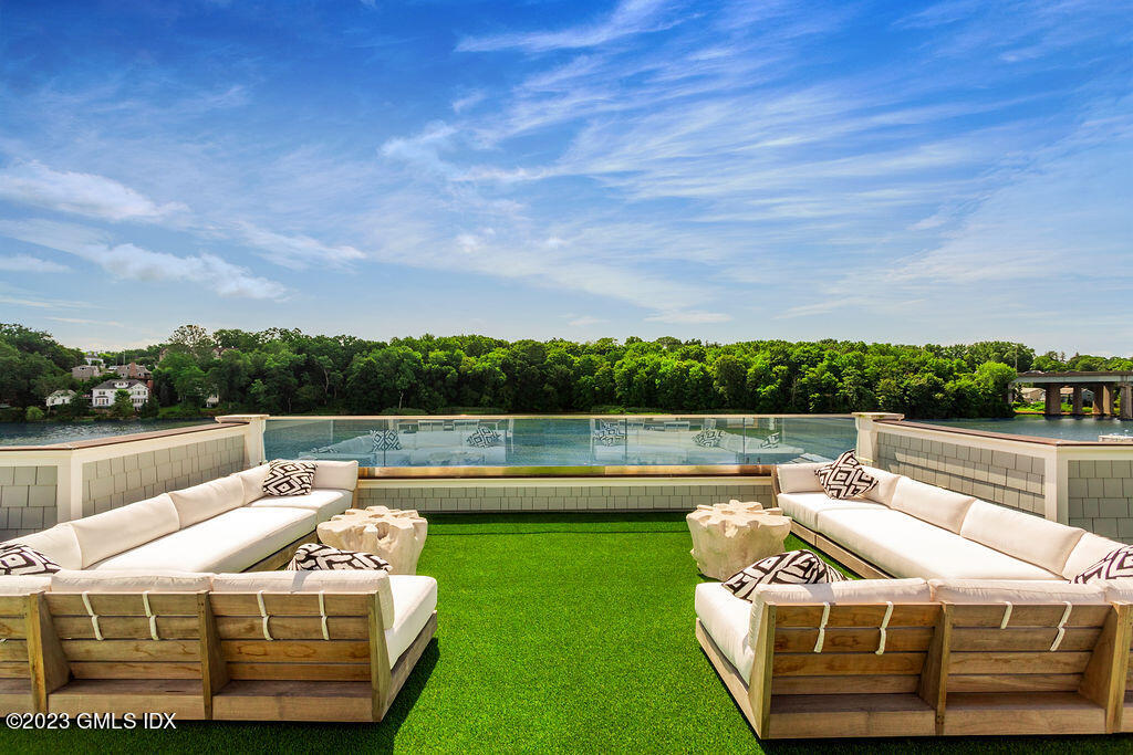 89 River Road, Unit 203 Cos Cob, CT 06807 - Photo 25 of 27 a view of a lake with couches chairs