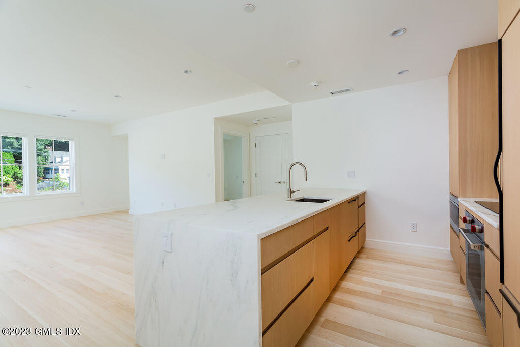 89 River Road, Unit 203 Cos Cob, CT 06807 - Photo 4 of 27 a view of a kitchen with sink and refrigerator