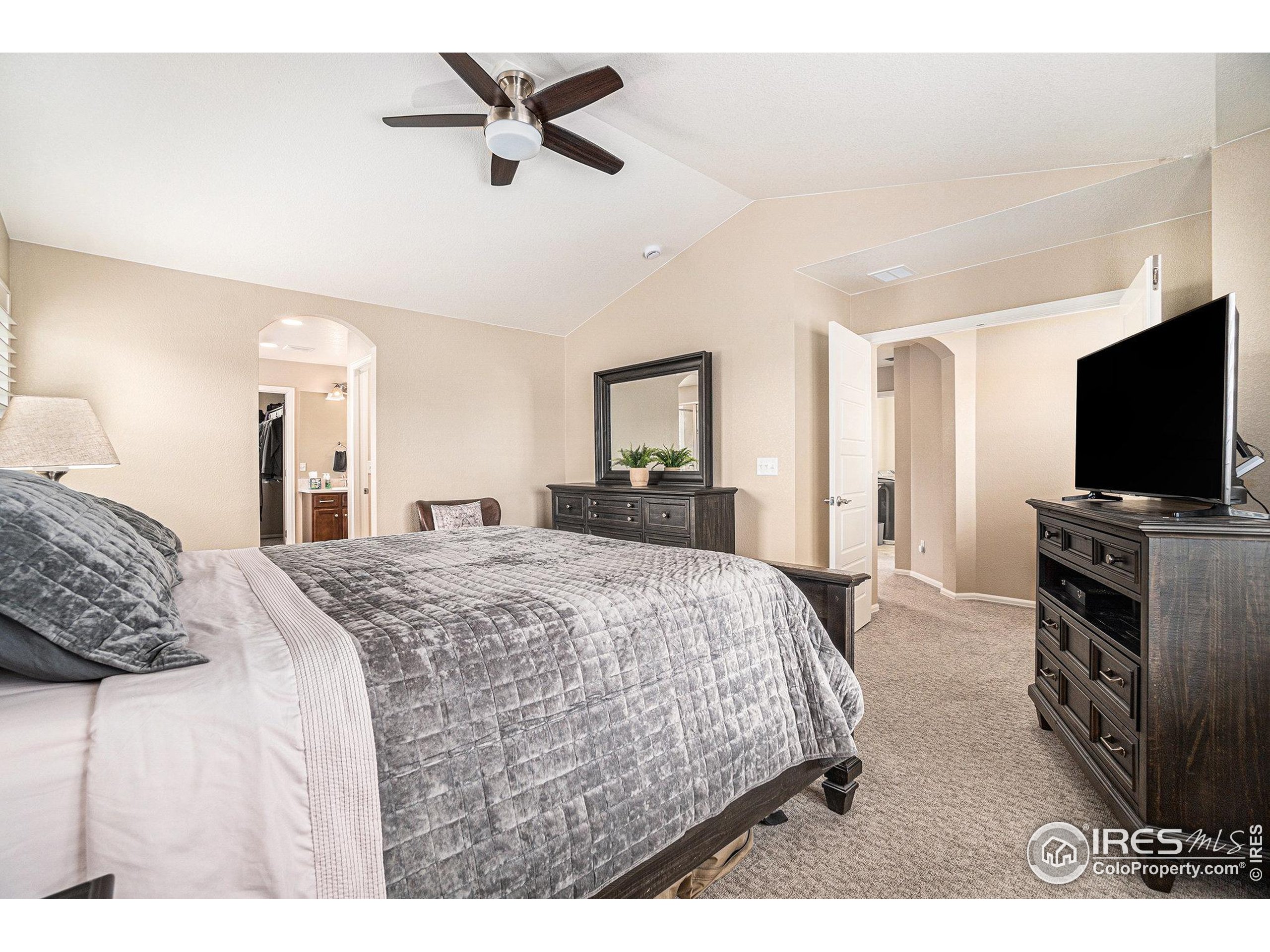 5622 Foxfire Street Timnath, CO 80547 - Photo 14 of 34 a bedroom with a bed and a flat screen tv