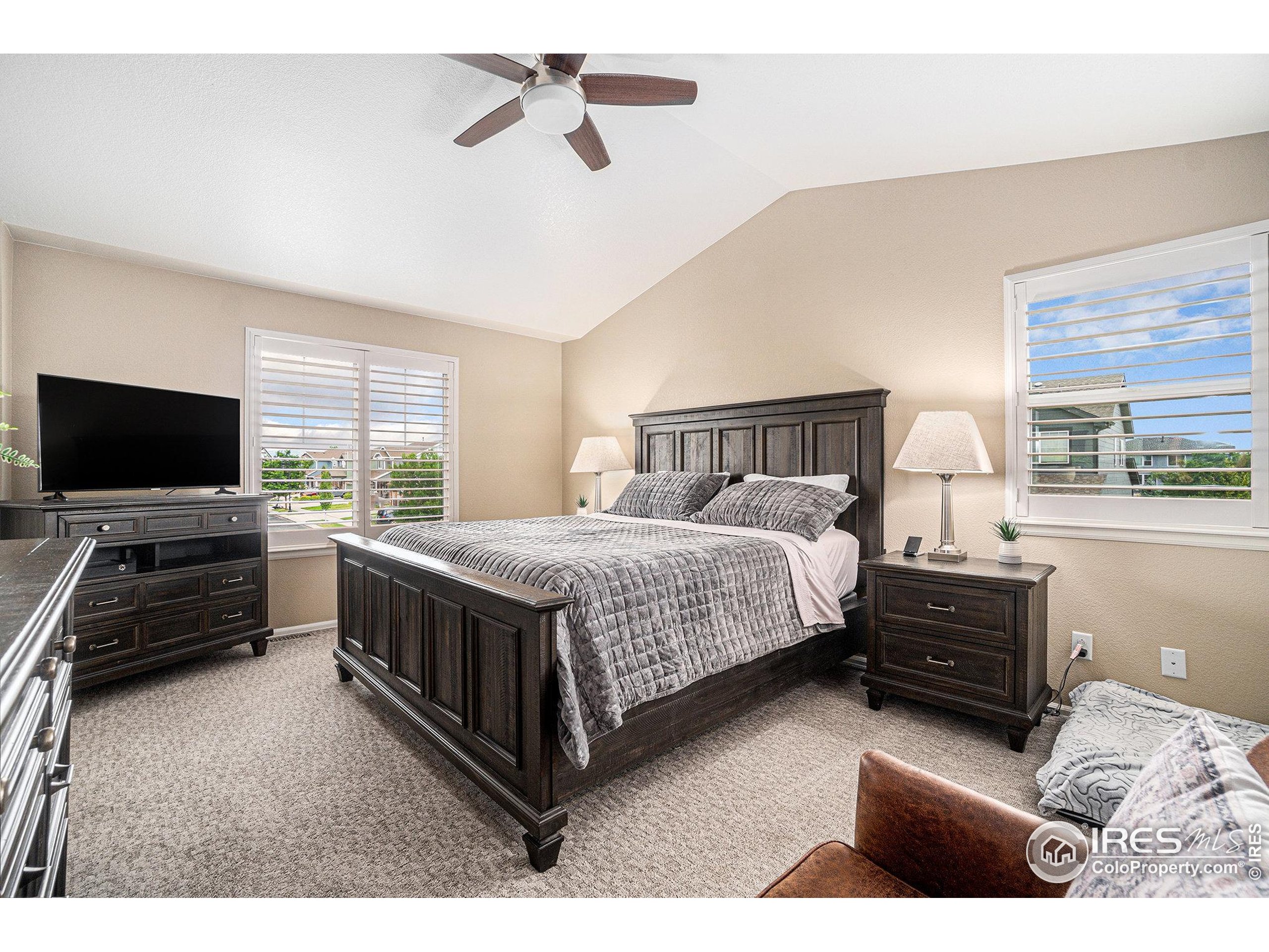 5622 Foxfire Street Timnath, CO 80547 - Photo 15 of 34 a bedroom with a bed and a flat tv screen on dresser