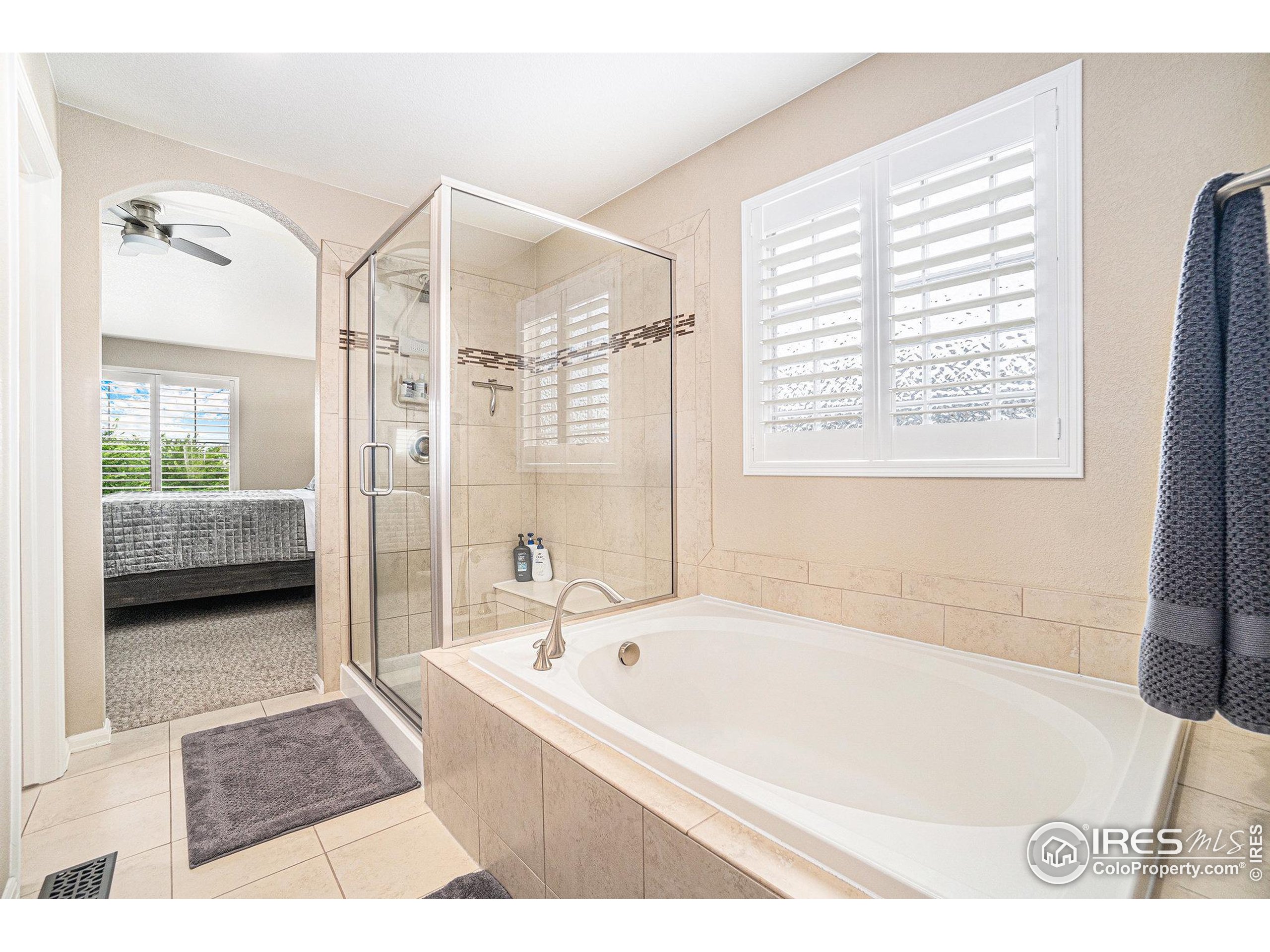 5622 Foxfire Street Timnath, CO 80547 - Photo 16 of 34 a bathroom with a bathtub and a shower