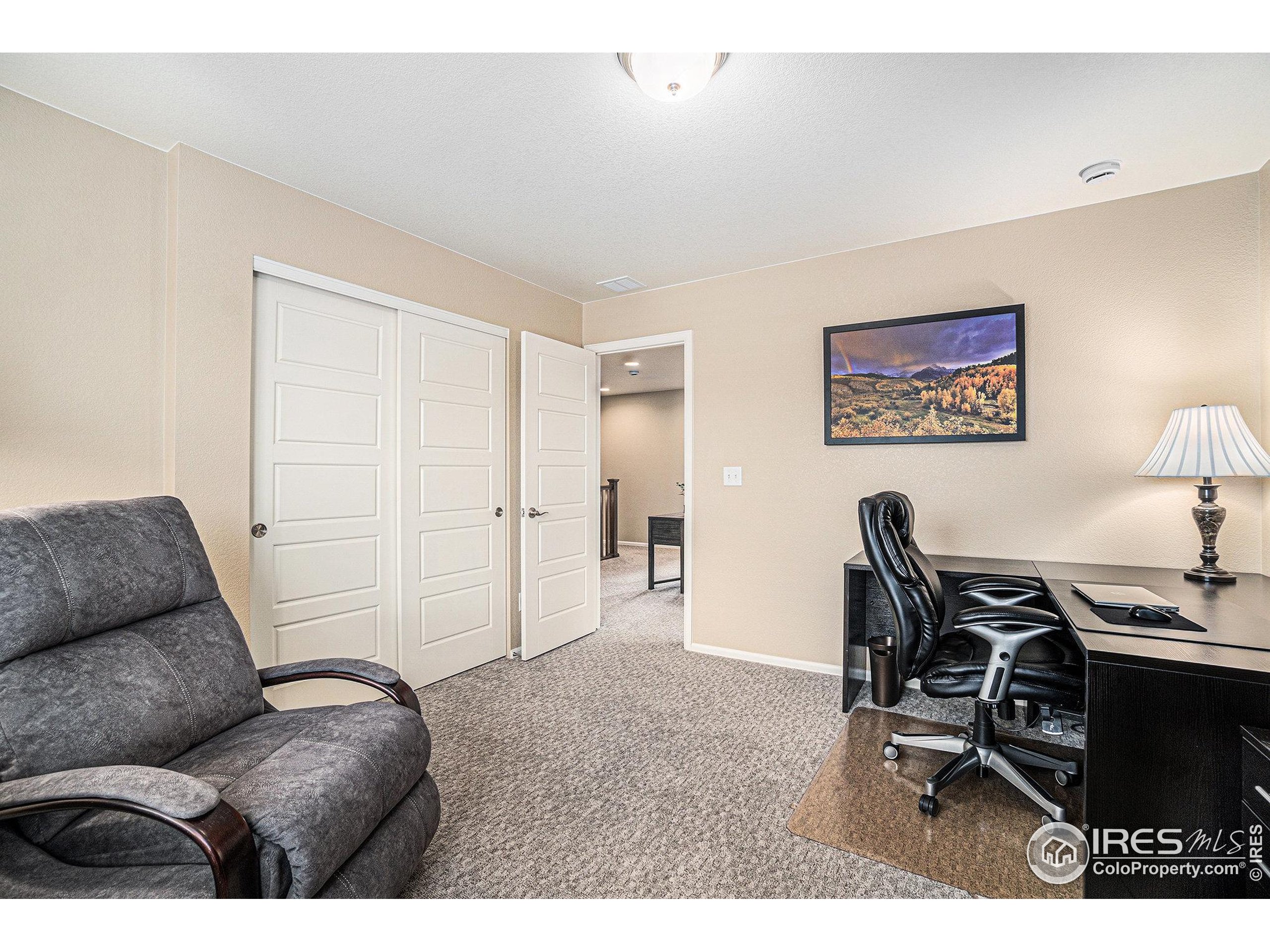 5622 Foxfire Street Timnath, CO 80547 - Photo 18 of 34 a living room with furniture and wooden floor