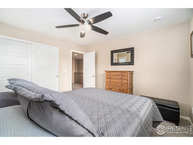 a bedroom with a large bed and a couch