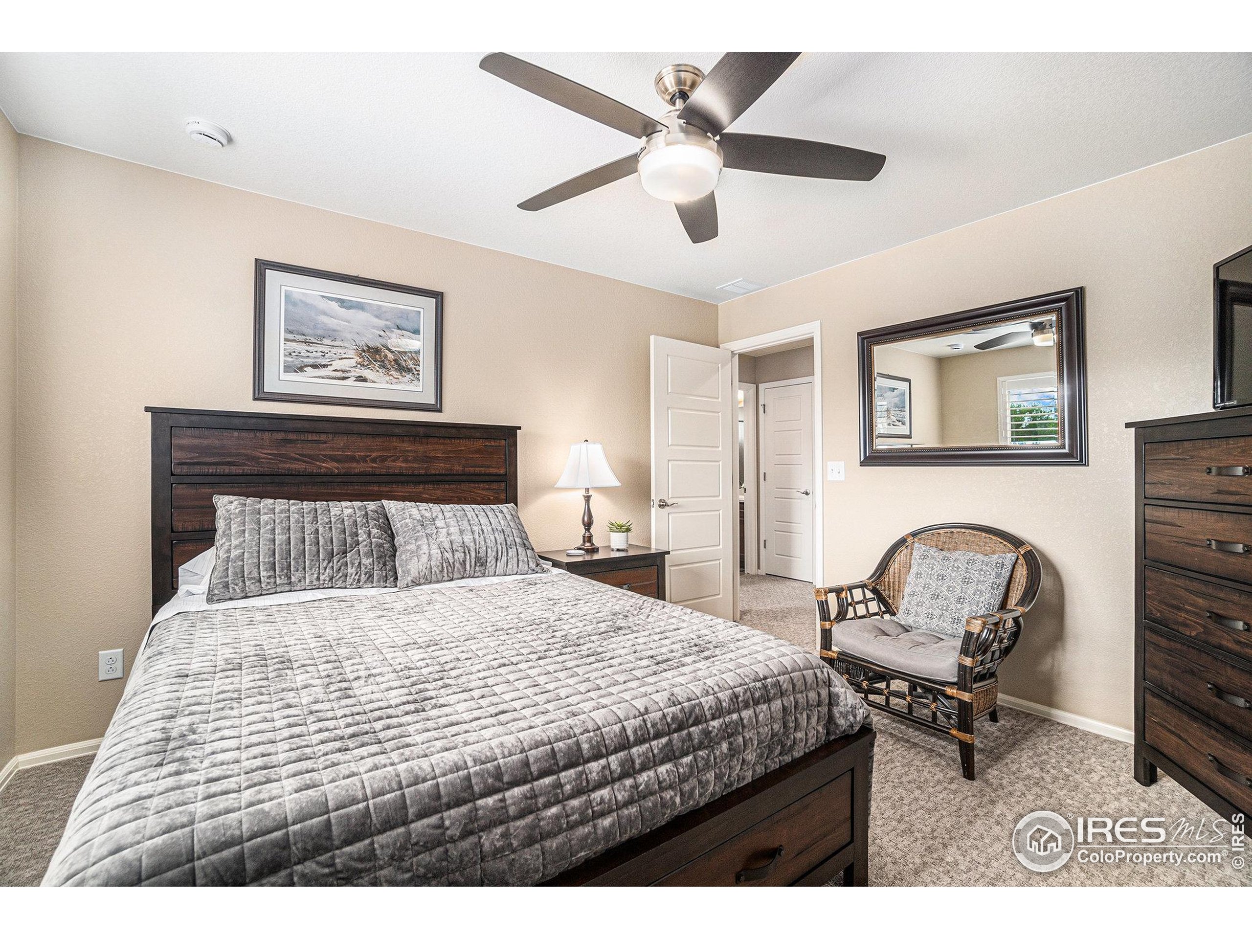 5622 Foxfire Street Timnath, CO 80547 - Photo 23 of 34 a bedroom with a bed and a chair