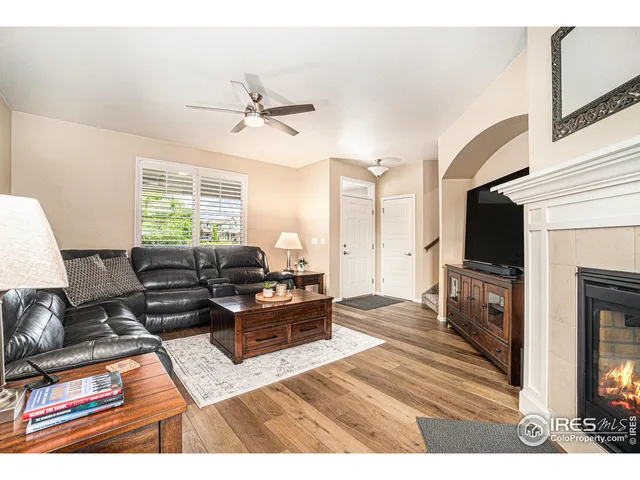 a living room with furniture flat screen tv and a fireplace