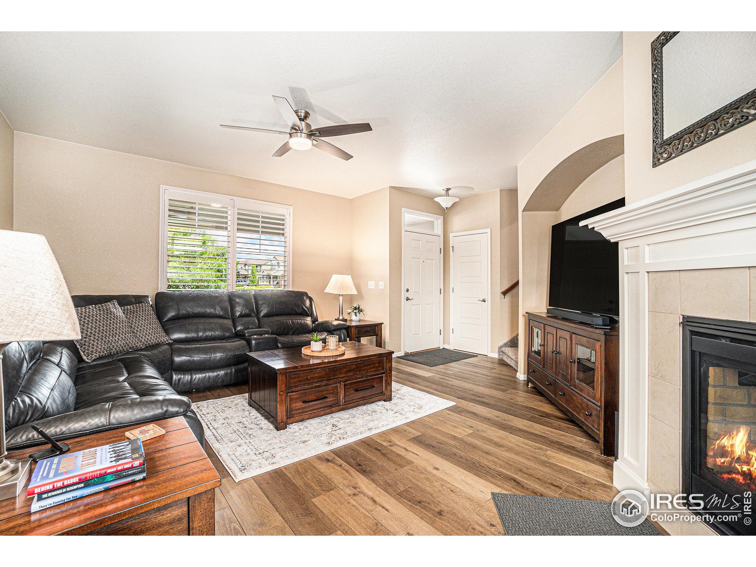 5622 Foxfire Street Timnath, CO 80547 - Photo 5 of 34 a living room with furniture flat screen tv and a fireplace