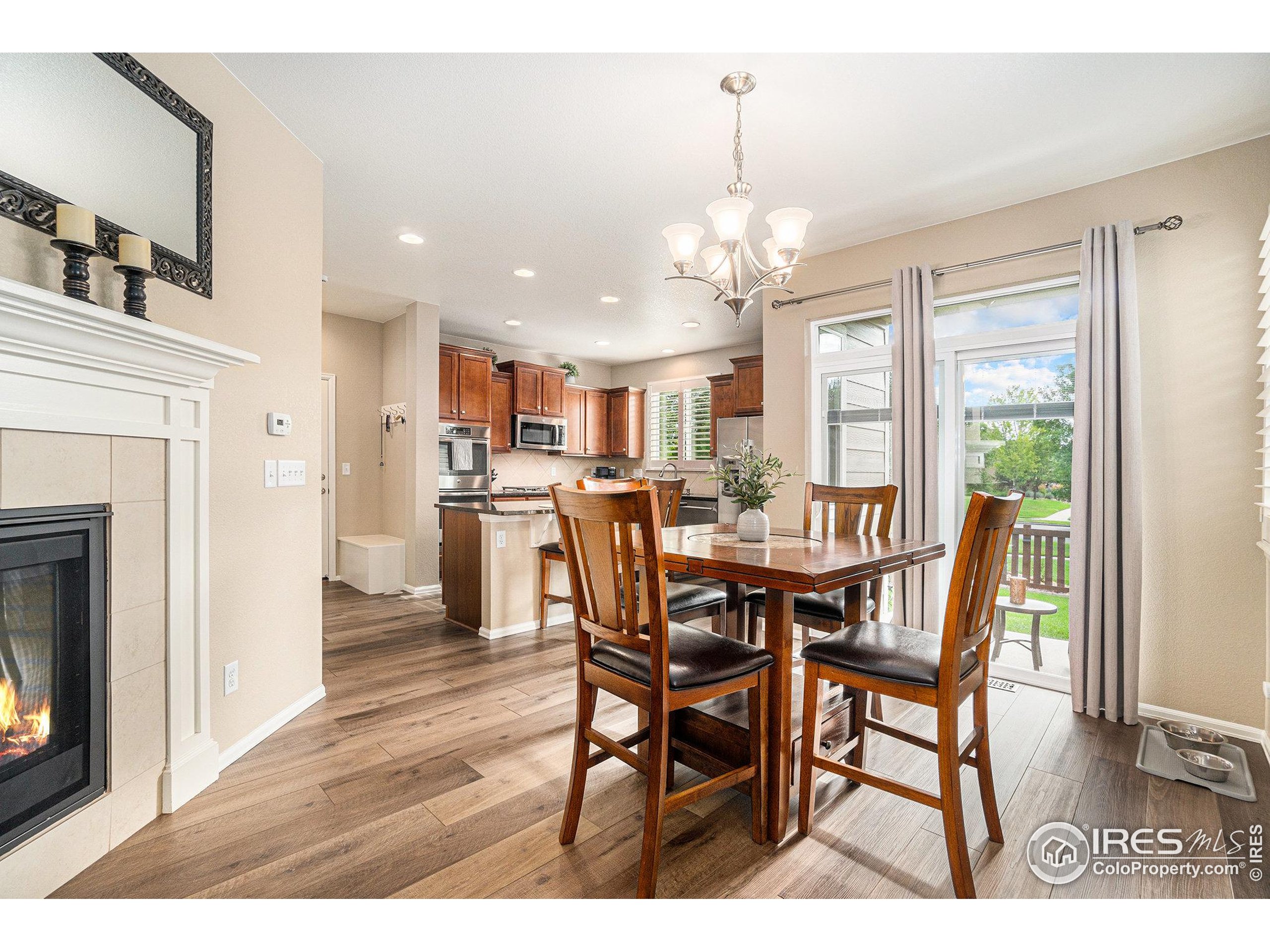5622 Foxfire Street Timnath, CO 80547 - Photo 8 of 34 a view of a dining room with furniture and chandelier
