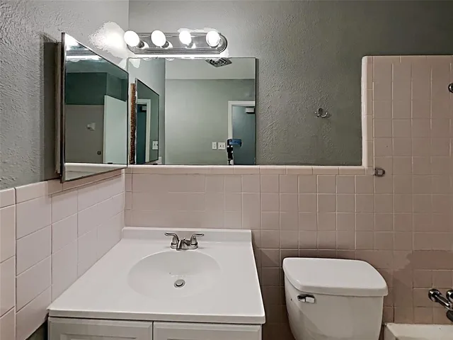 a bathroom with a toilet and a bathtub