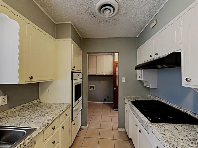 a kitchen with a stove and a sink