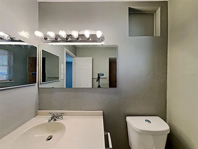 a view of an empty room with a chandelier fan