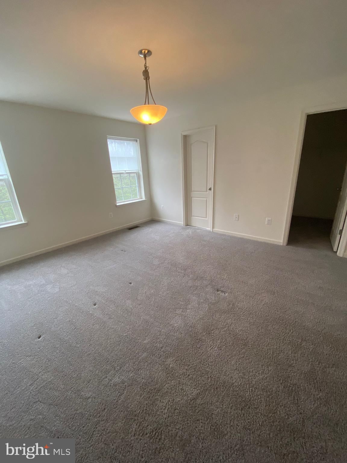 918 Ramble Run Road Baltimore, MD 21220 - Photo 14 of 23 a view of an empty room with a fireplace and a window