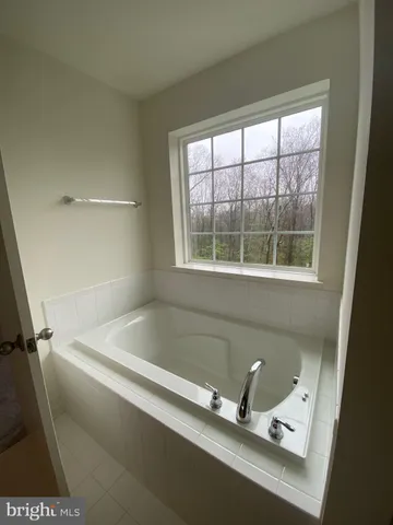 a bath tub sitting next to a window