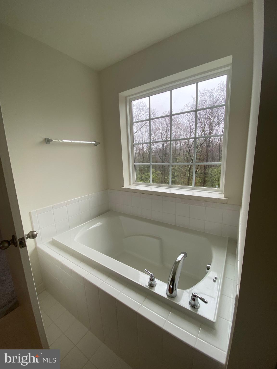 918 Ramble Run Road Baltimore, MD 21220 - Photo 17 of 23 a bath tub sitting next to a window