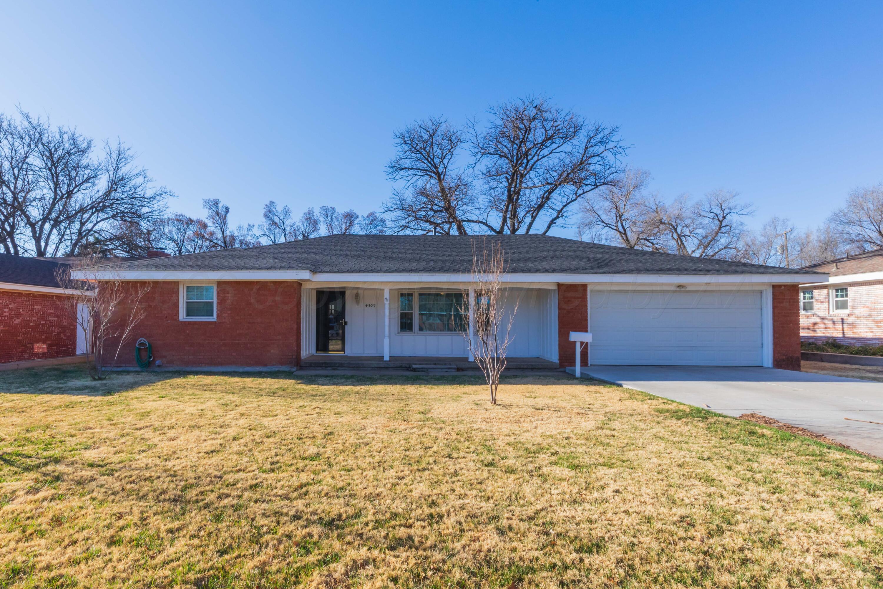 4309 Olsen Boulevard Amarillo, TX 79106 - Photo 1 of 45 a view of a house with a yard