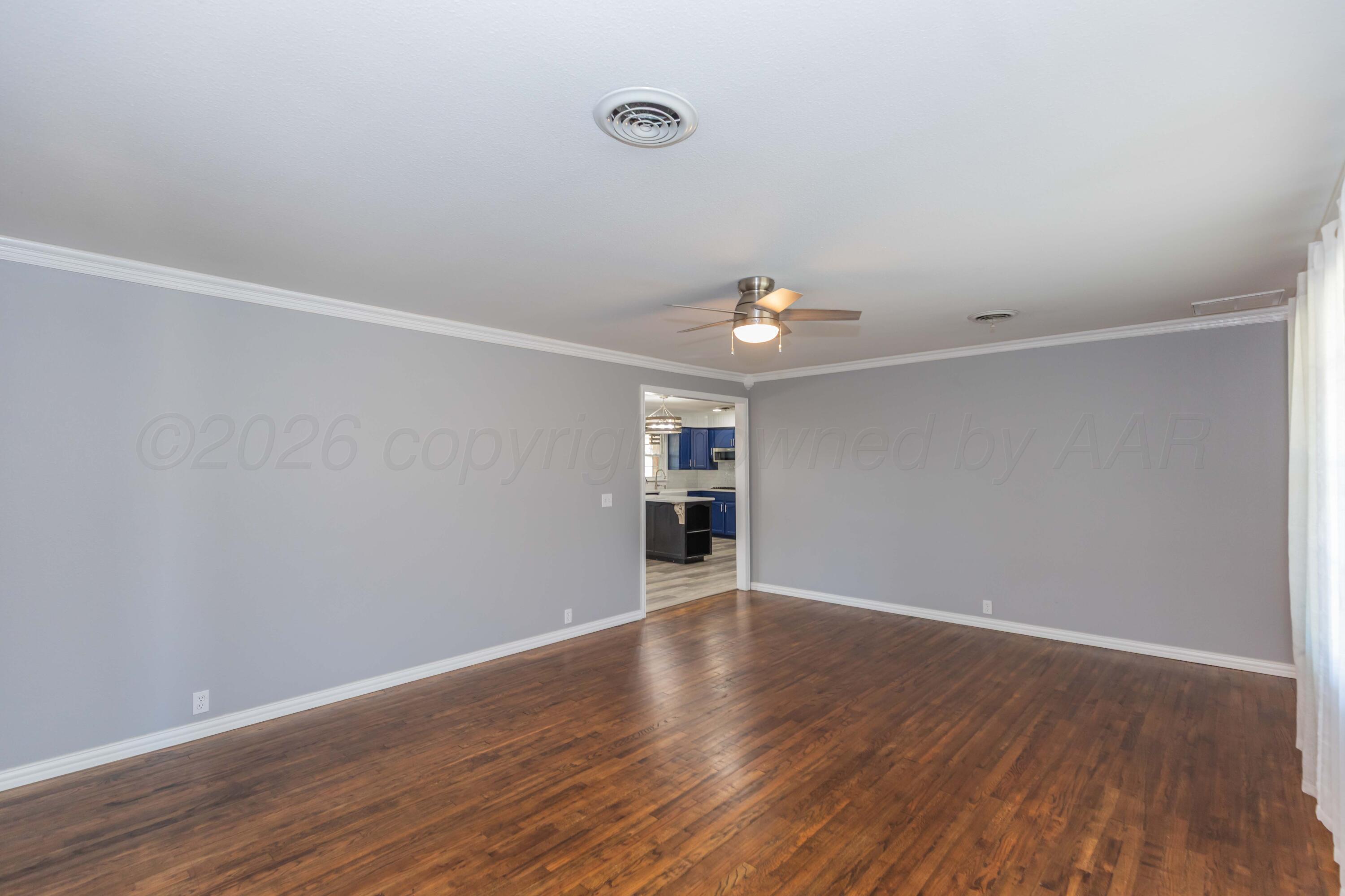 4309 Olsen Boulevard Amarillo, TX 79106 - Photo 11 of 45 a view of an empty room with wooden floor and a window