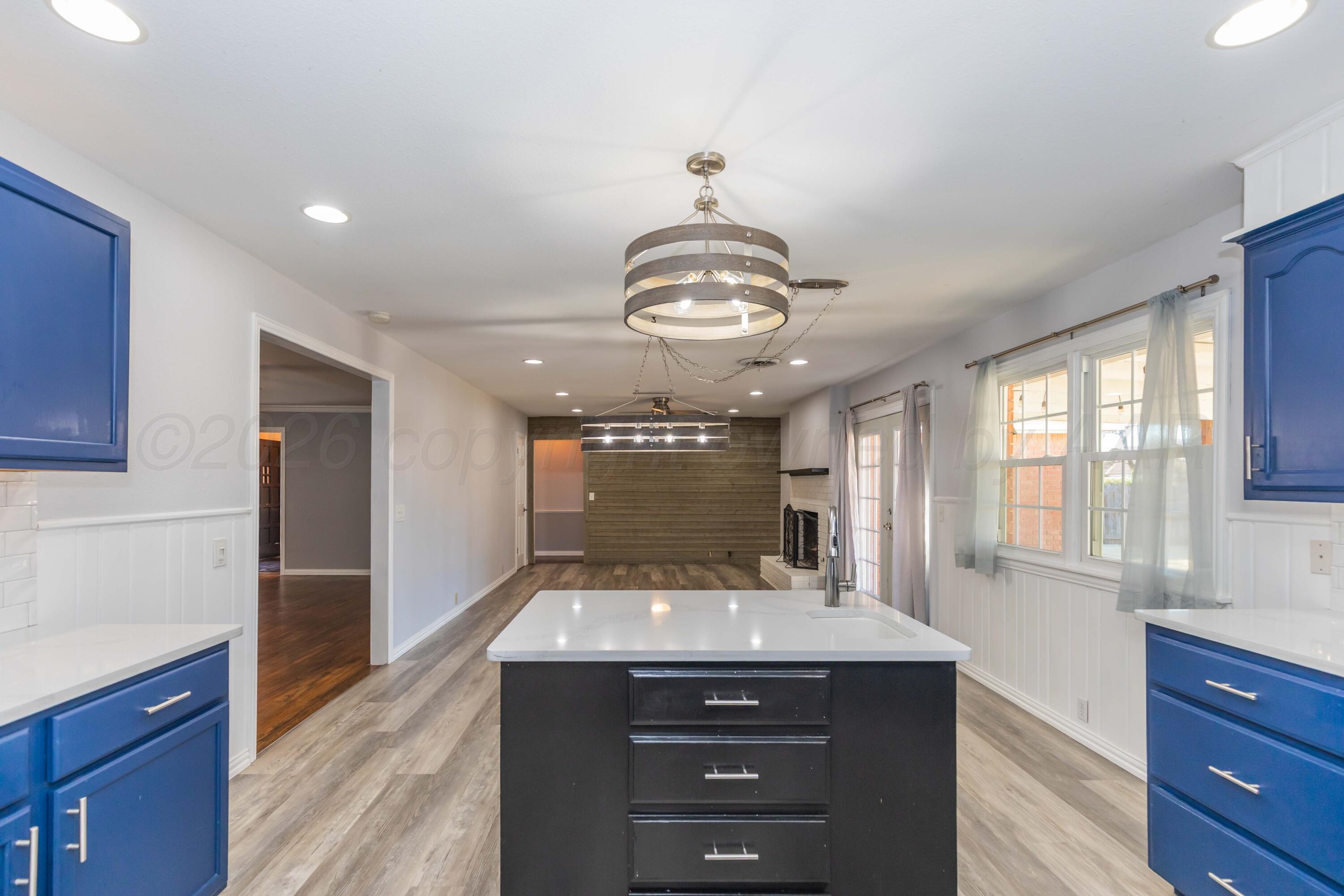 4309 Olsen Boulevard Amarillo, TX 79106 - Photo 16 of 45 a view of a center island and chandelier in a kitchen