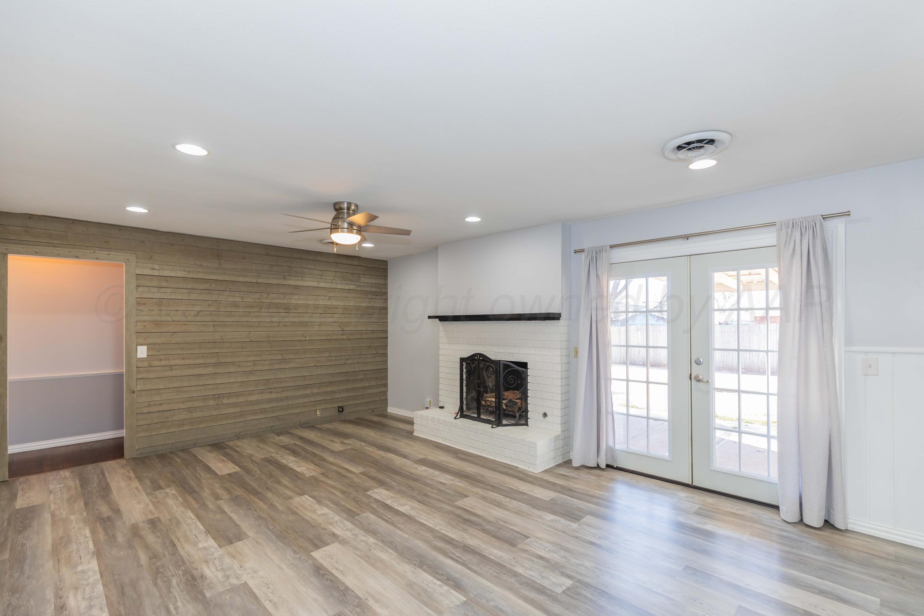 4309 Olsen Boulevard Amarillo, TX 79106 - Photo 18 of 45 wooden floor in an empty room with a fireplace