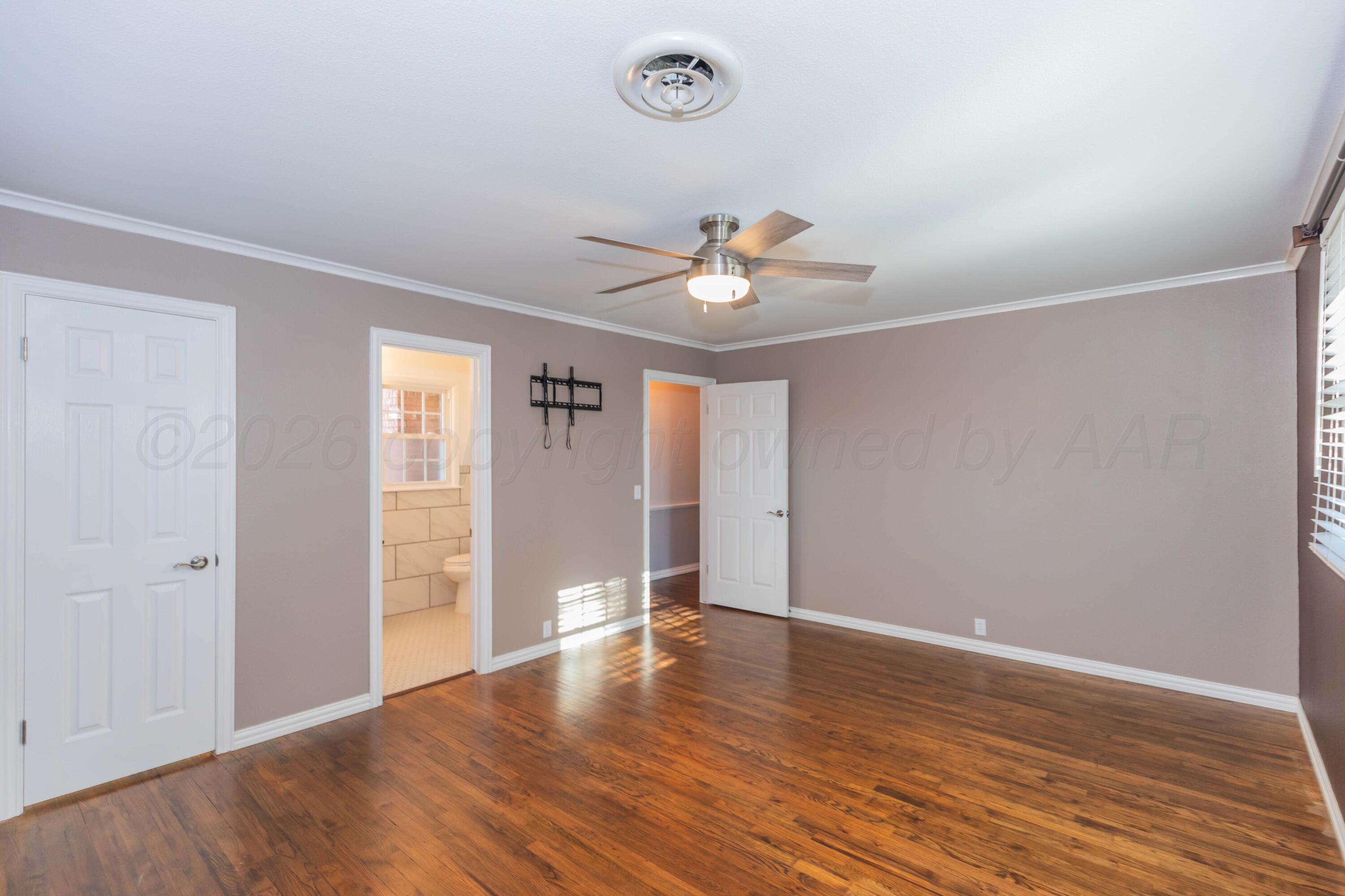 4309 Olsen Boulevard Amarillo, TX 79106 - Photo 22 of 45 an empty room with wooden floor and window