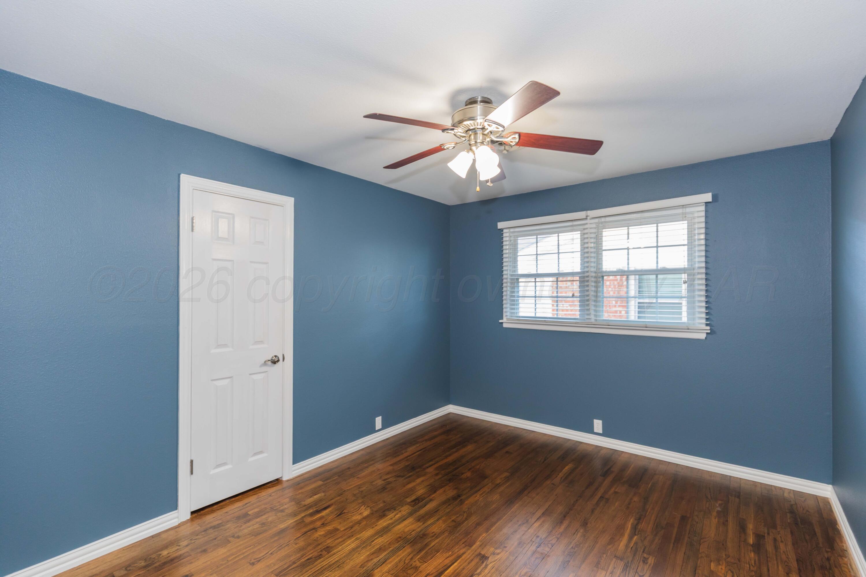 4309 Olsen Boulevard Amarillo, TX 79106 - Photo 27 of 45 wooden floor in an empty room with a window