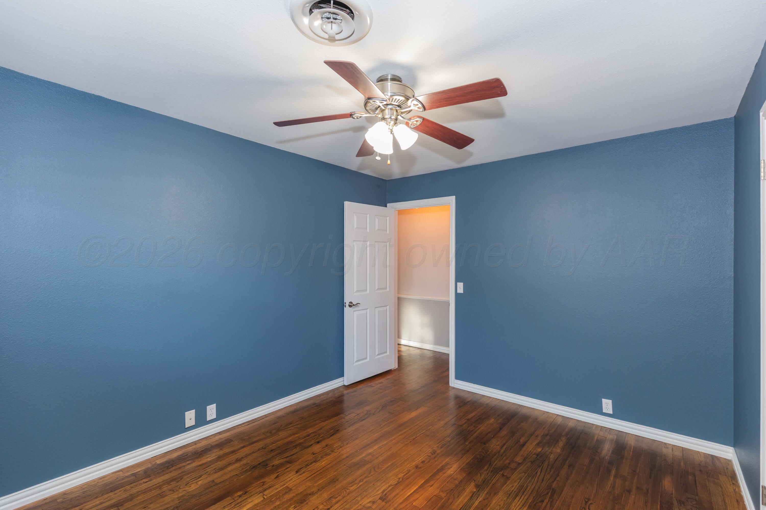 4309 Olsen Boulevard Amarillo, TX 79106 - Photo 29 of 45 a view of an empty room with window and wooden floor