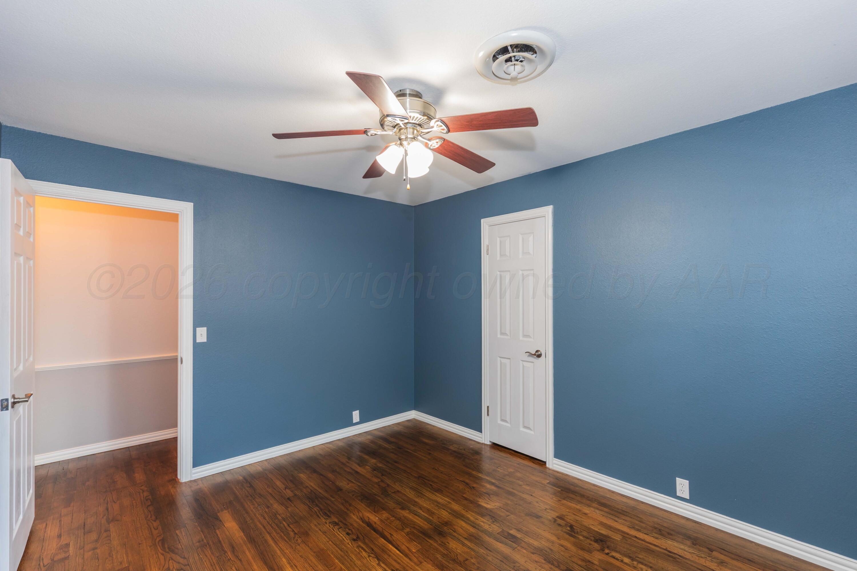 4309 Olsen Boulevard Amarillo, TX 79106 - Photo 30 of 45 wooden floor in an empty room with a window