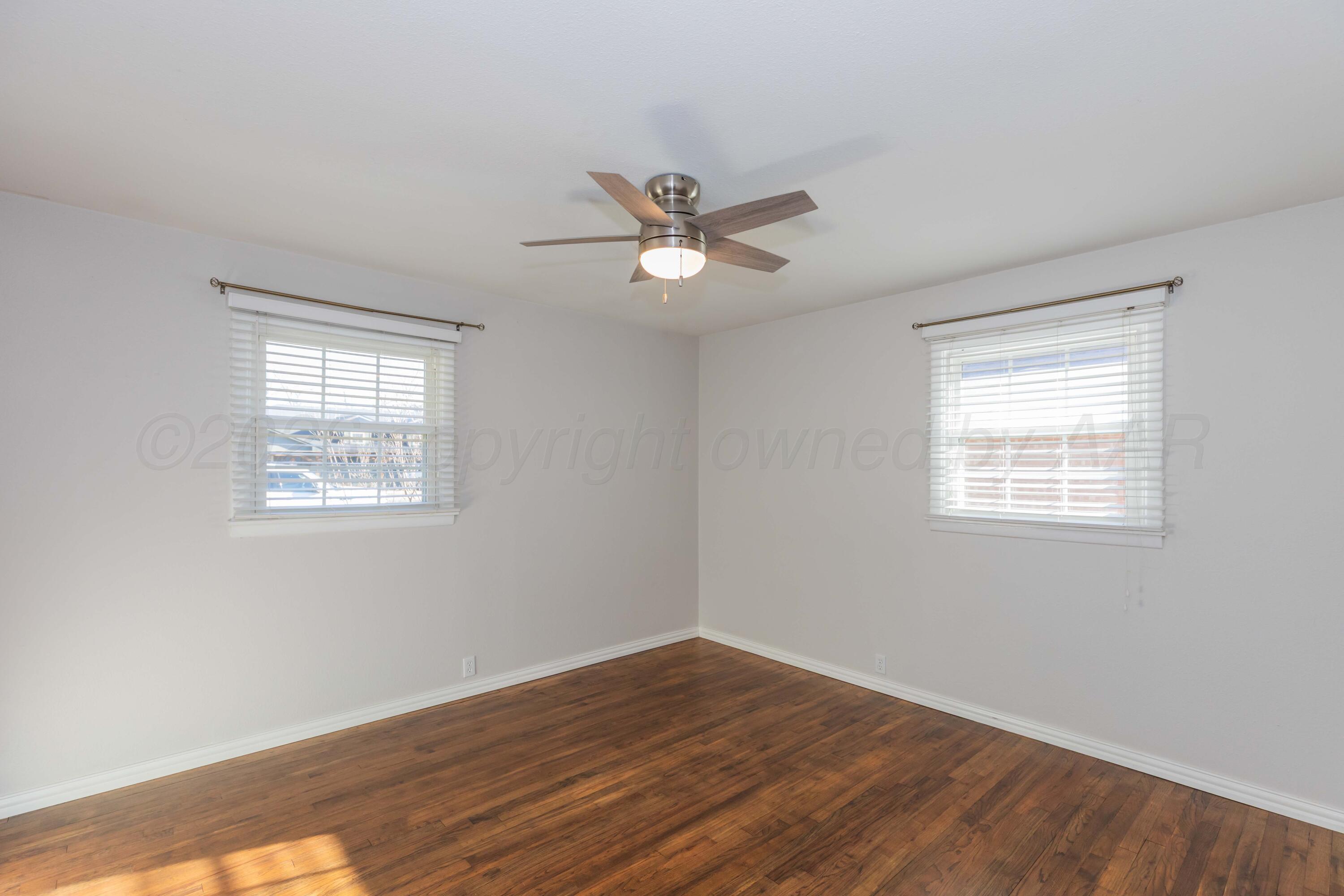 4309 Olsen Boulevard Amarillo, TX 79106 - Photo 34 of 45 a view of a room with wooden floor and a ceiling fan