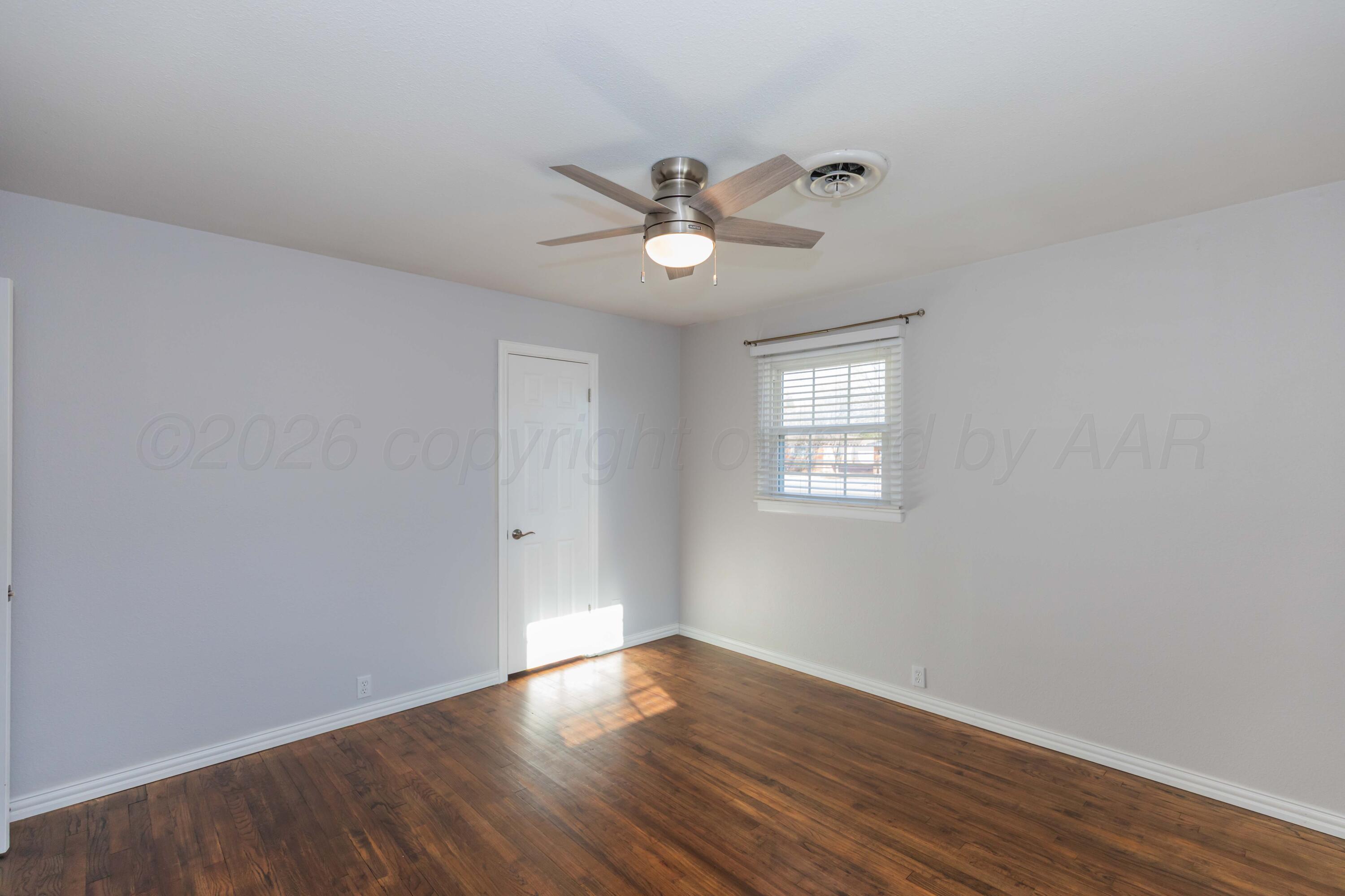 4309 Olsen Boulevard Amarillo, TX 79106 - Photo 35 of 45 a view of empty room with wooden floor and fan