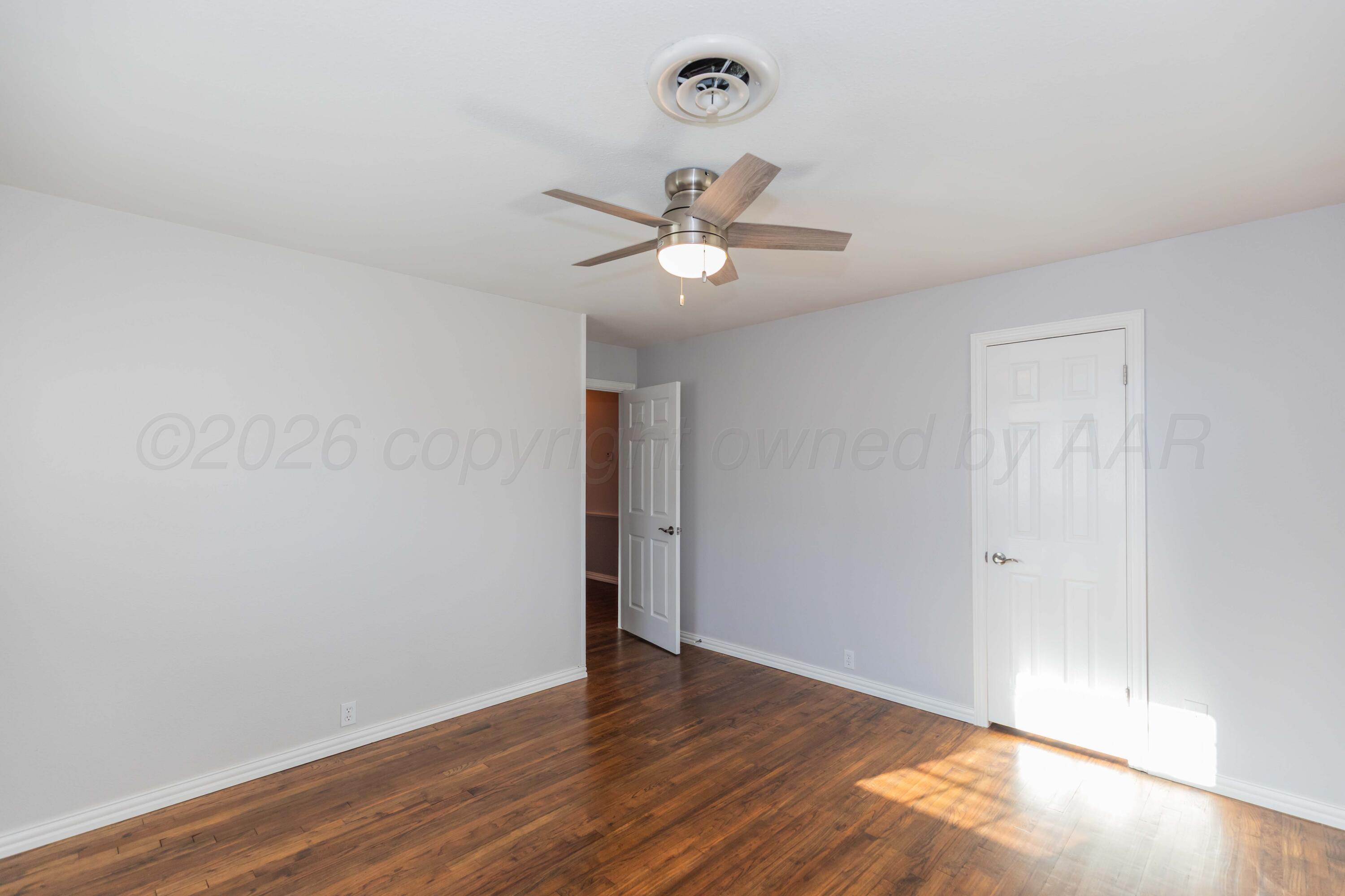 4309 Olsen Boulevard Amarillo, TX 79106 - Photo 36 of 45 a view of a room with wooden floor and a ceiling fan