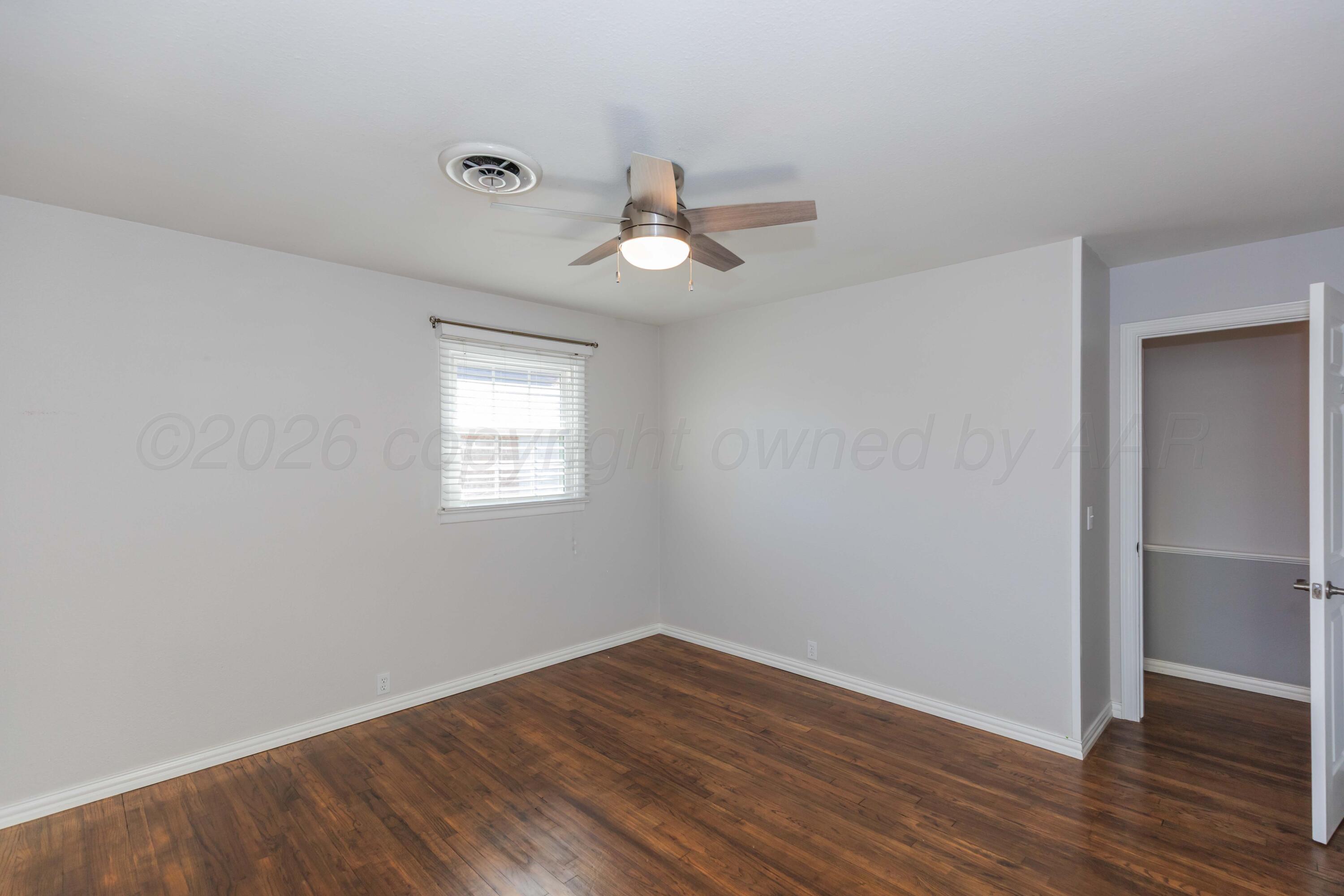 4309 Olsen Boulevard Amarillo, TX 79106 - Photo 37 of 45 wooden floor in an empty room with a window