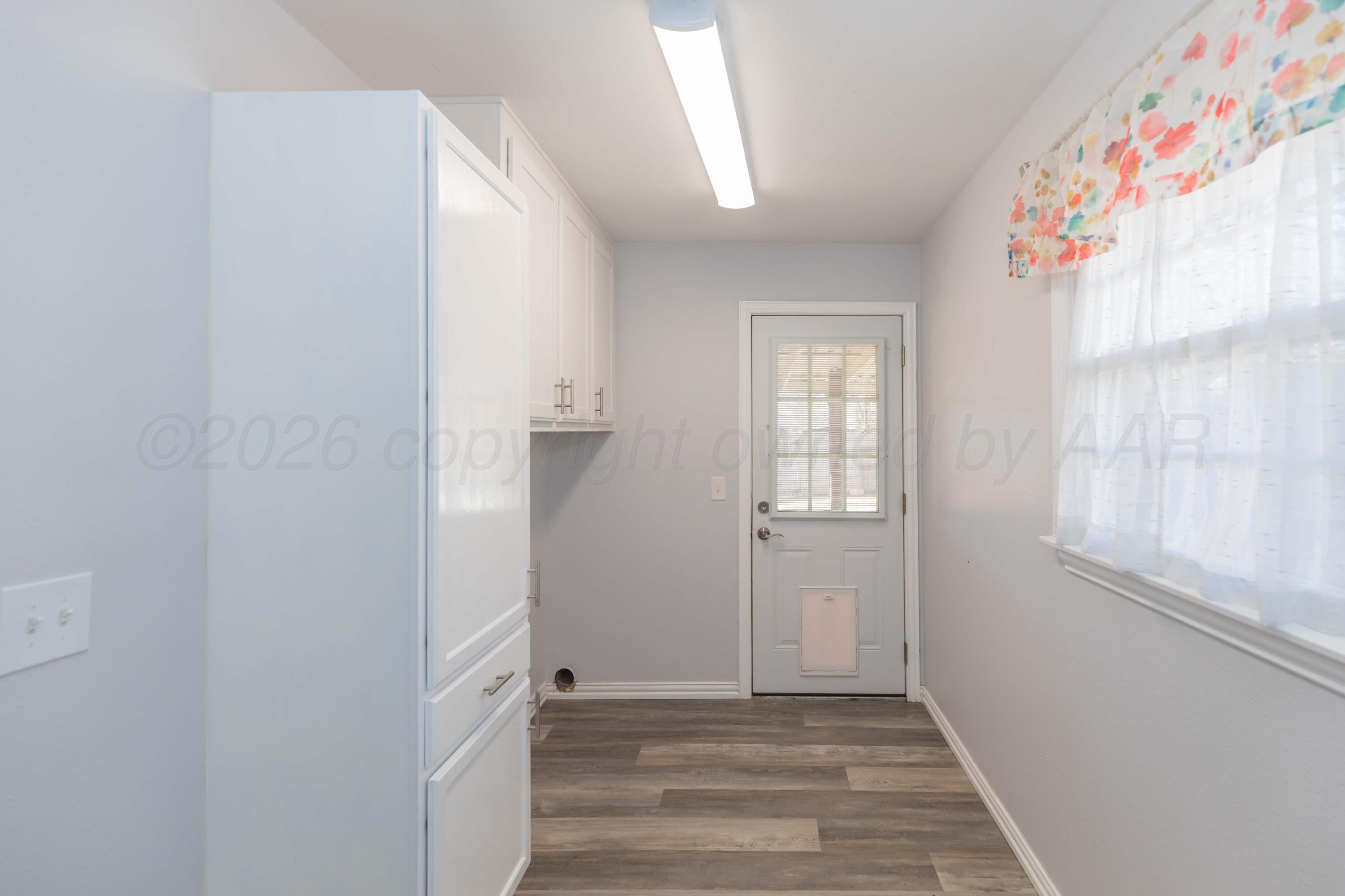 4309 Olsen Boulevard Amarillo, TX 79106 - Photo 39 of 45 a view of an empty room with wooden floor and a window