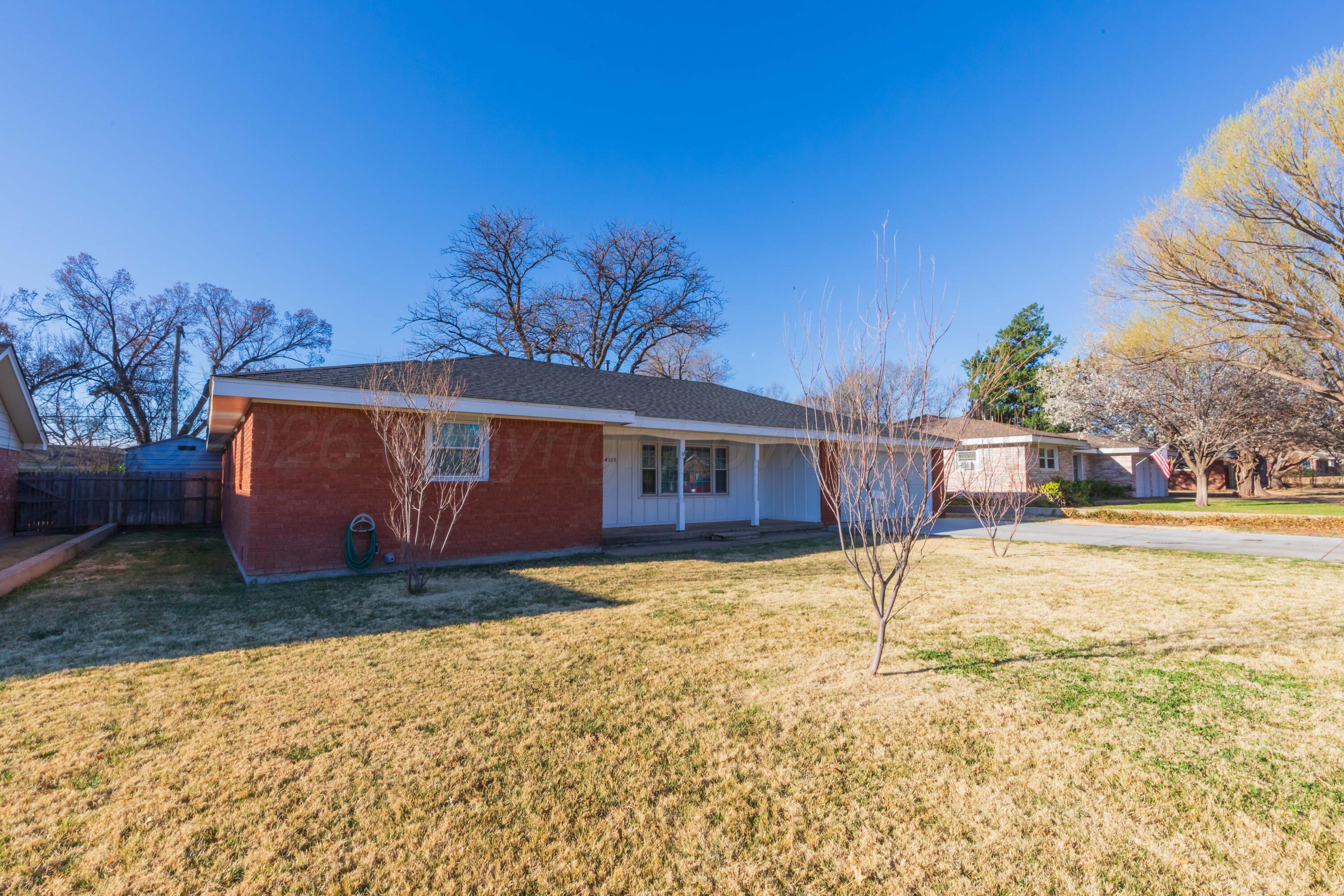 4309 Olsen Boulevard Amarillo, TX 79106 - Photo 9 of 45 a view of a house with a yard