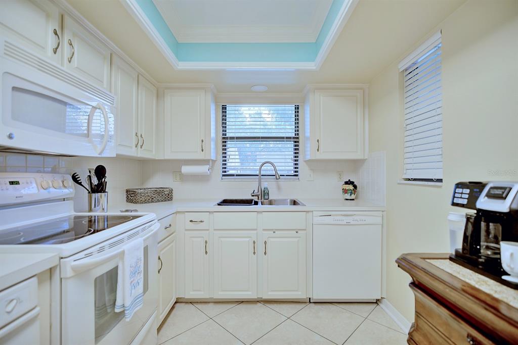 2025 Sylvester Road, Unit H2 Lakeland, FL 33803 - Photo 12 of 59 a kitchen with cabinets appliances a sink and a window